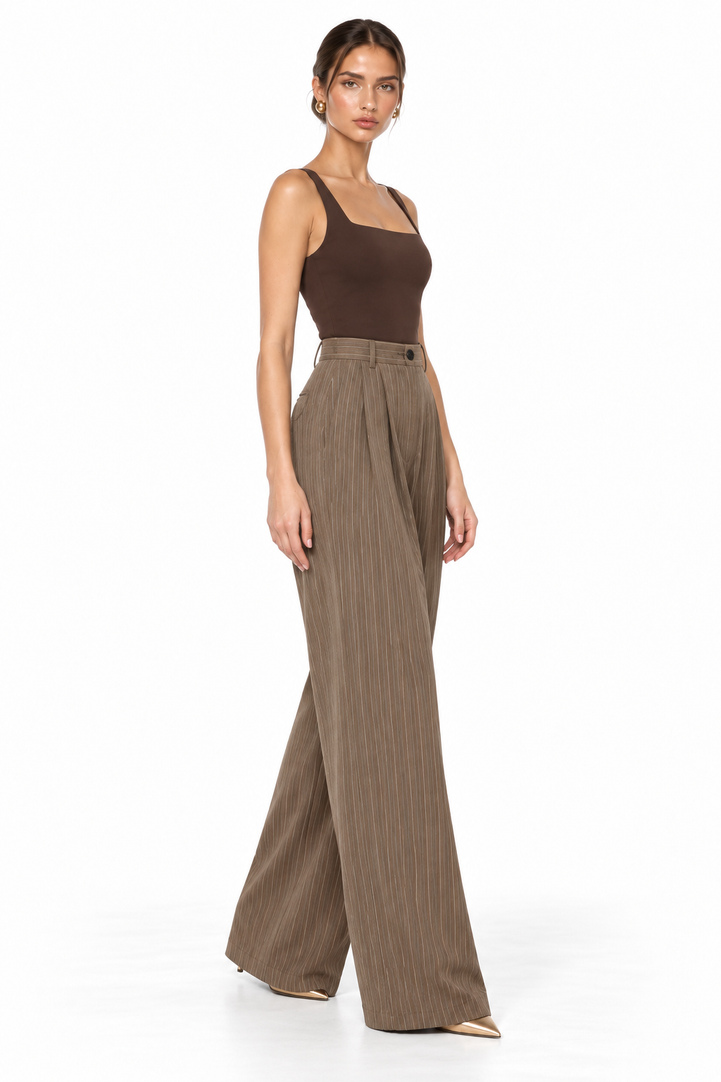 A woman modeling a brown sleeveless top and high-waisted, wide-leg taupe-brown pinstripe trousers against a plain white studio background.
